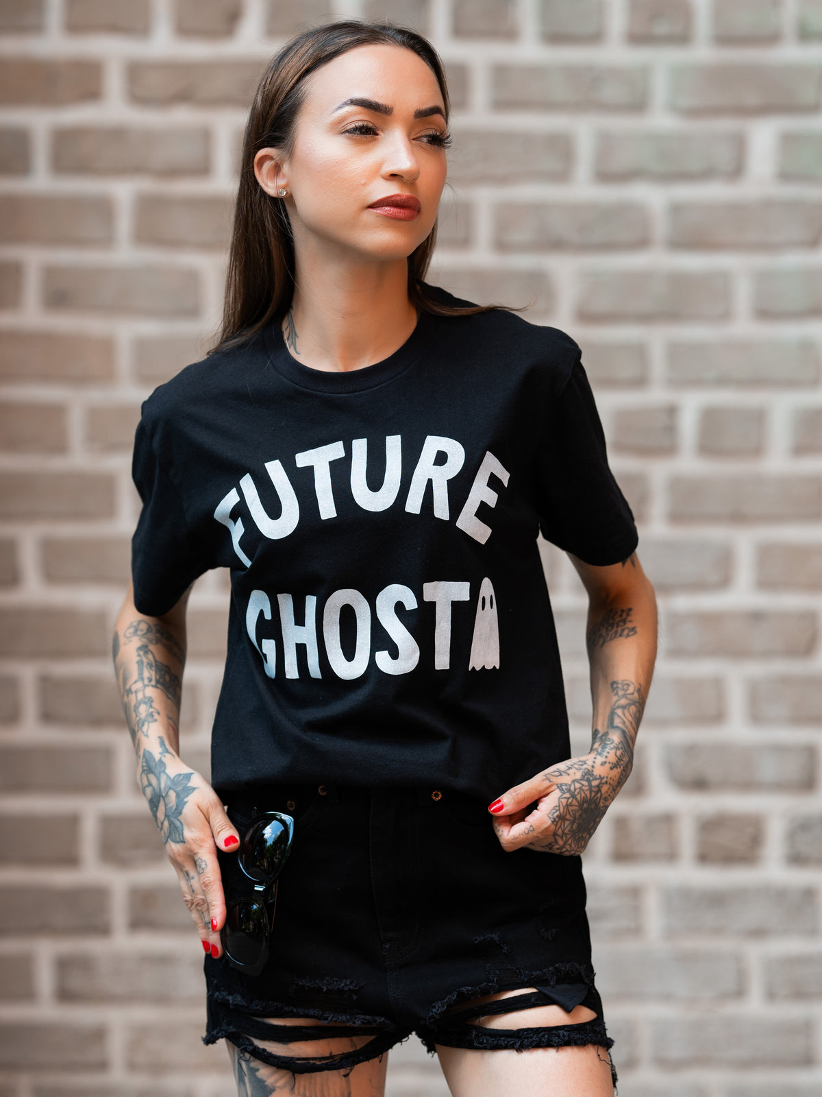 Janice Danger wearing a black, unisex t-shirt with a bold white graphic which reads &quot;future ghost&quot; 