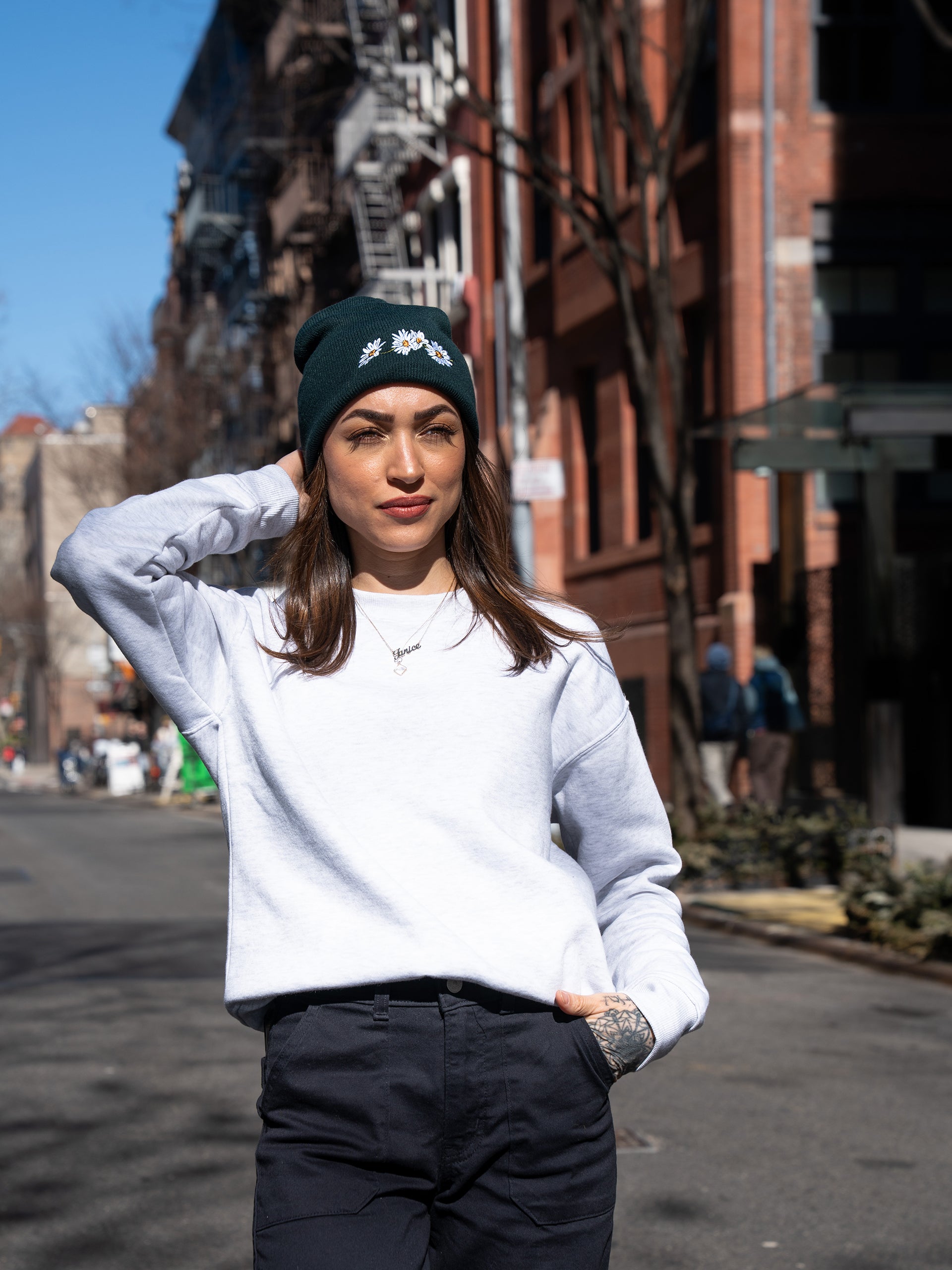 Janice Danger wearing the Nostalgic Daisy pine green beanie. Photographed on Sullivan Street NYC. 