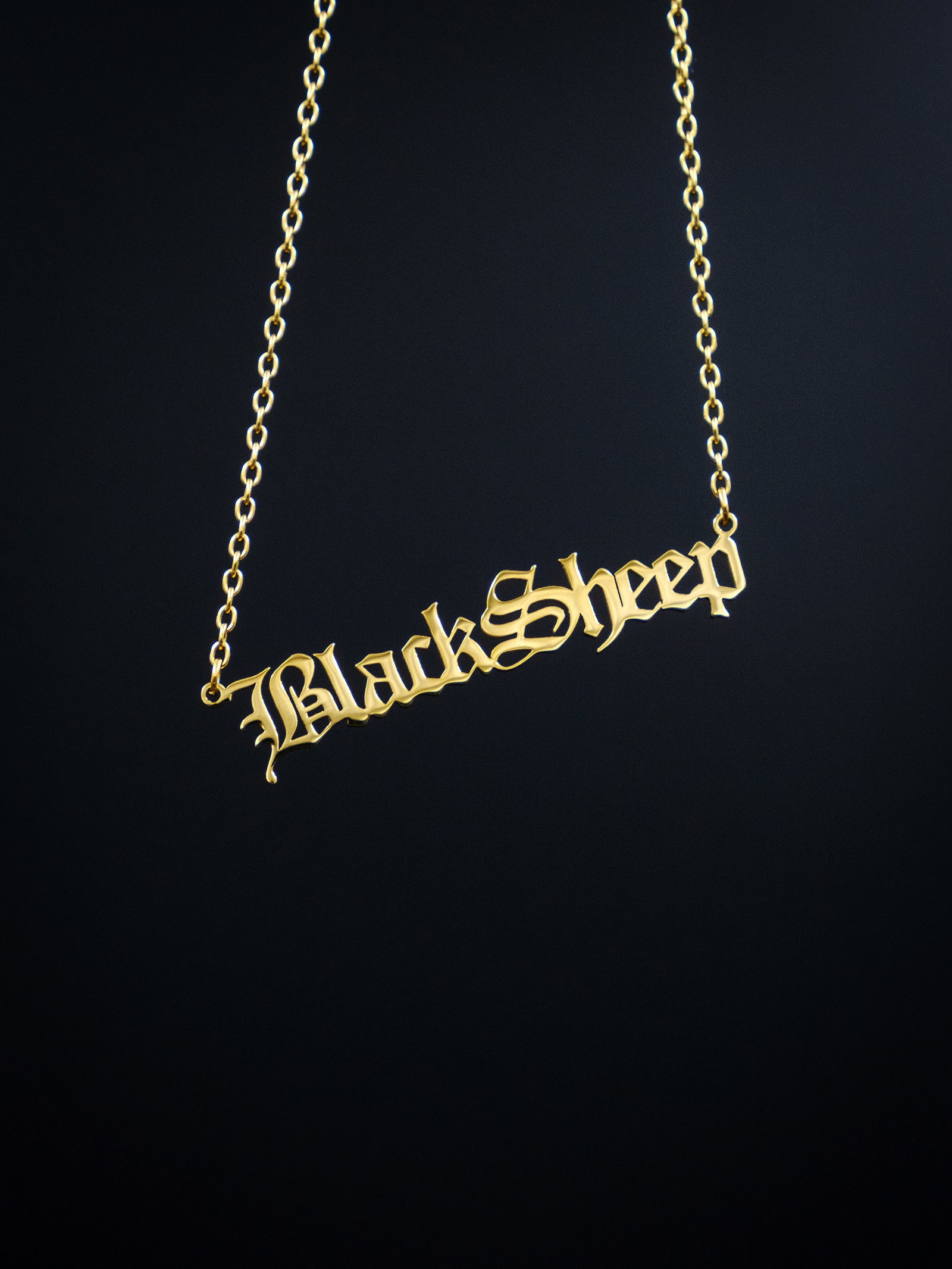 gold nameplate style necklace against a black background, reads BlackSheep in old english style font