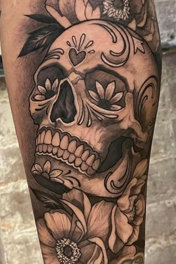 Black and Gray sugar skull  and floral tattoo by Elvia Guadian at Grit N Glory in New York City