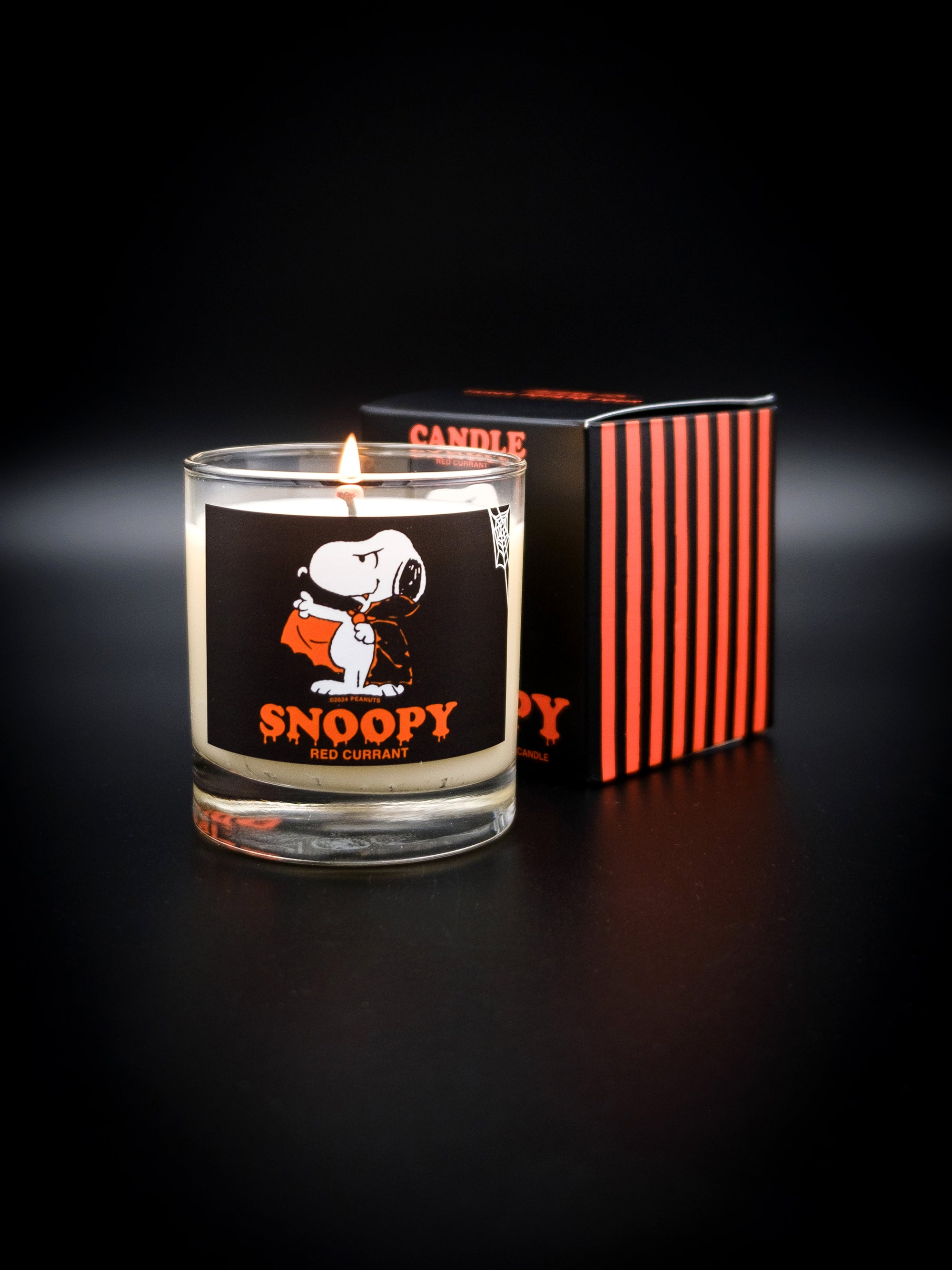 Lit votive Snoopy Candle. This candle features a drippy halloween themed Snoopy text with vampire Snoopy graphic. 