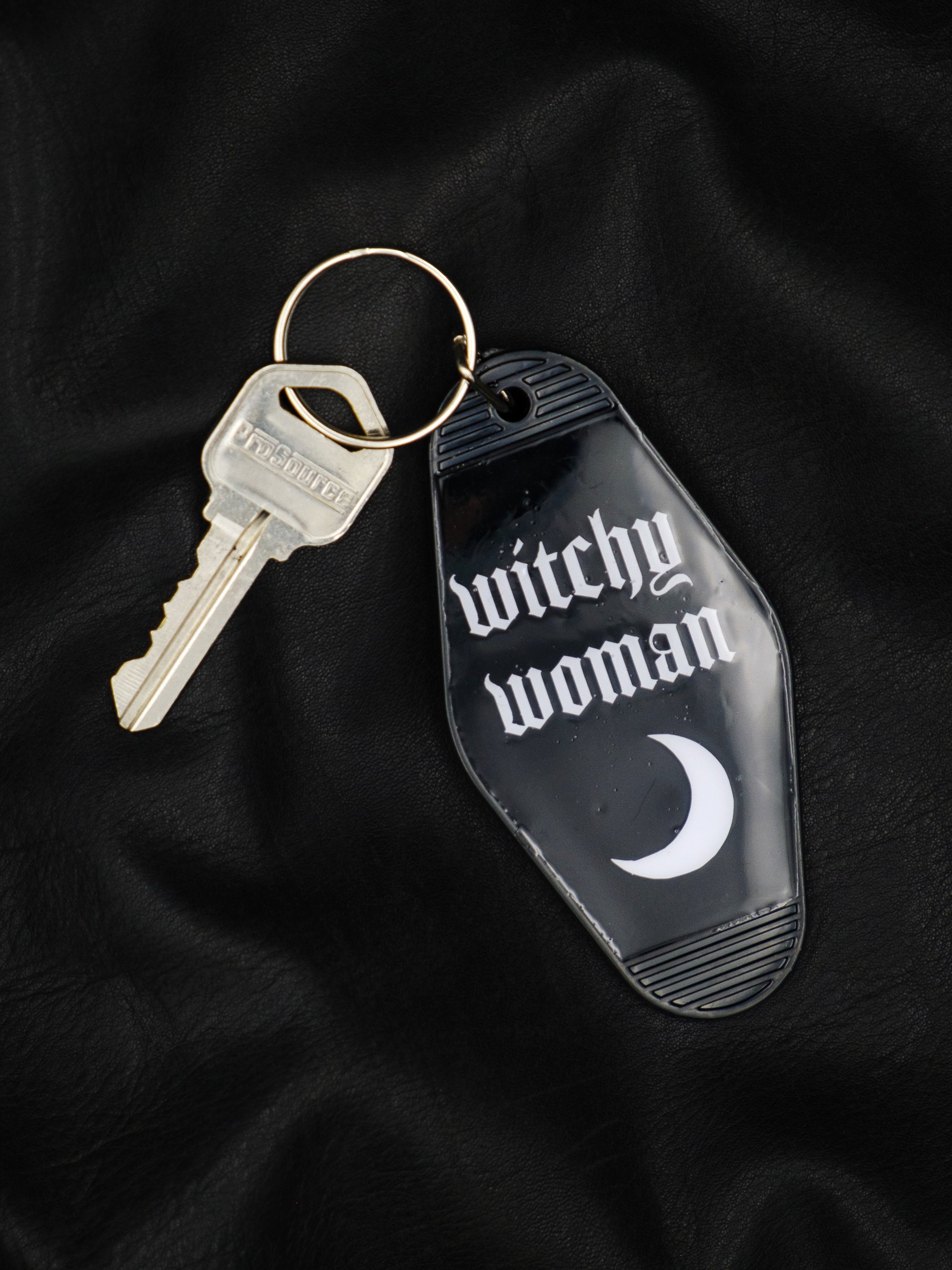 black motel style keychain with crescent moon reads witchy woman in white