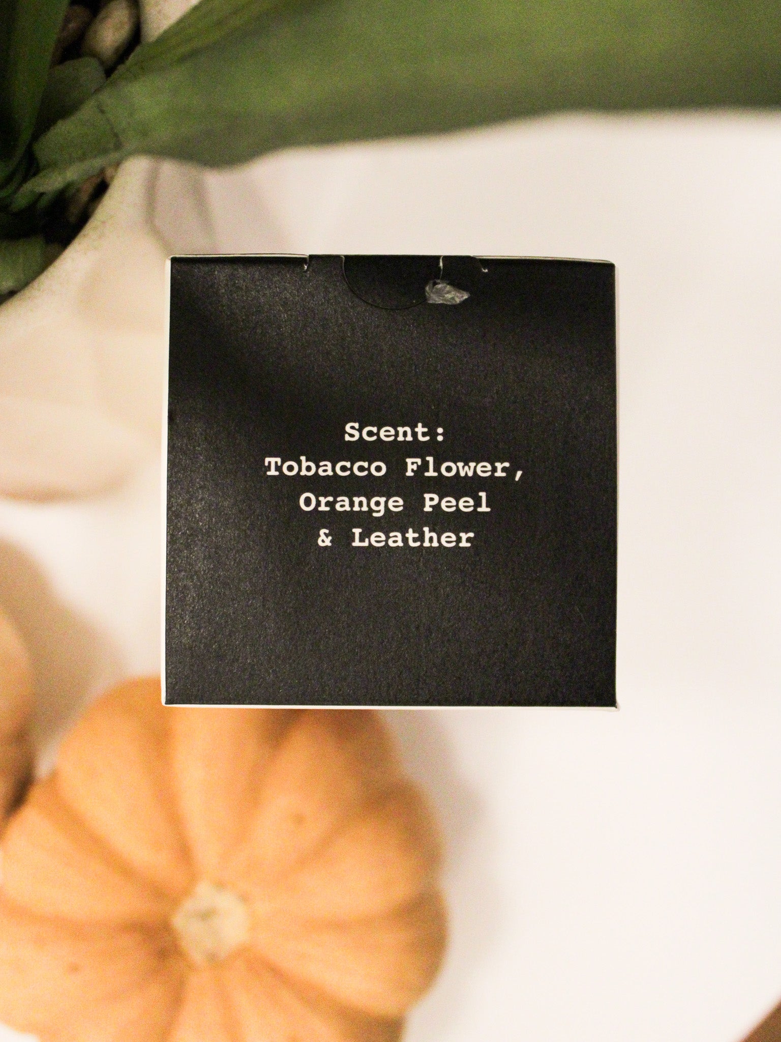 scente details for the Death Tarot Candle reads Tobacco Flower, Orange Peel & Leather