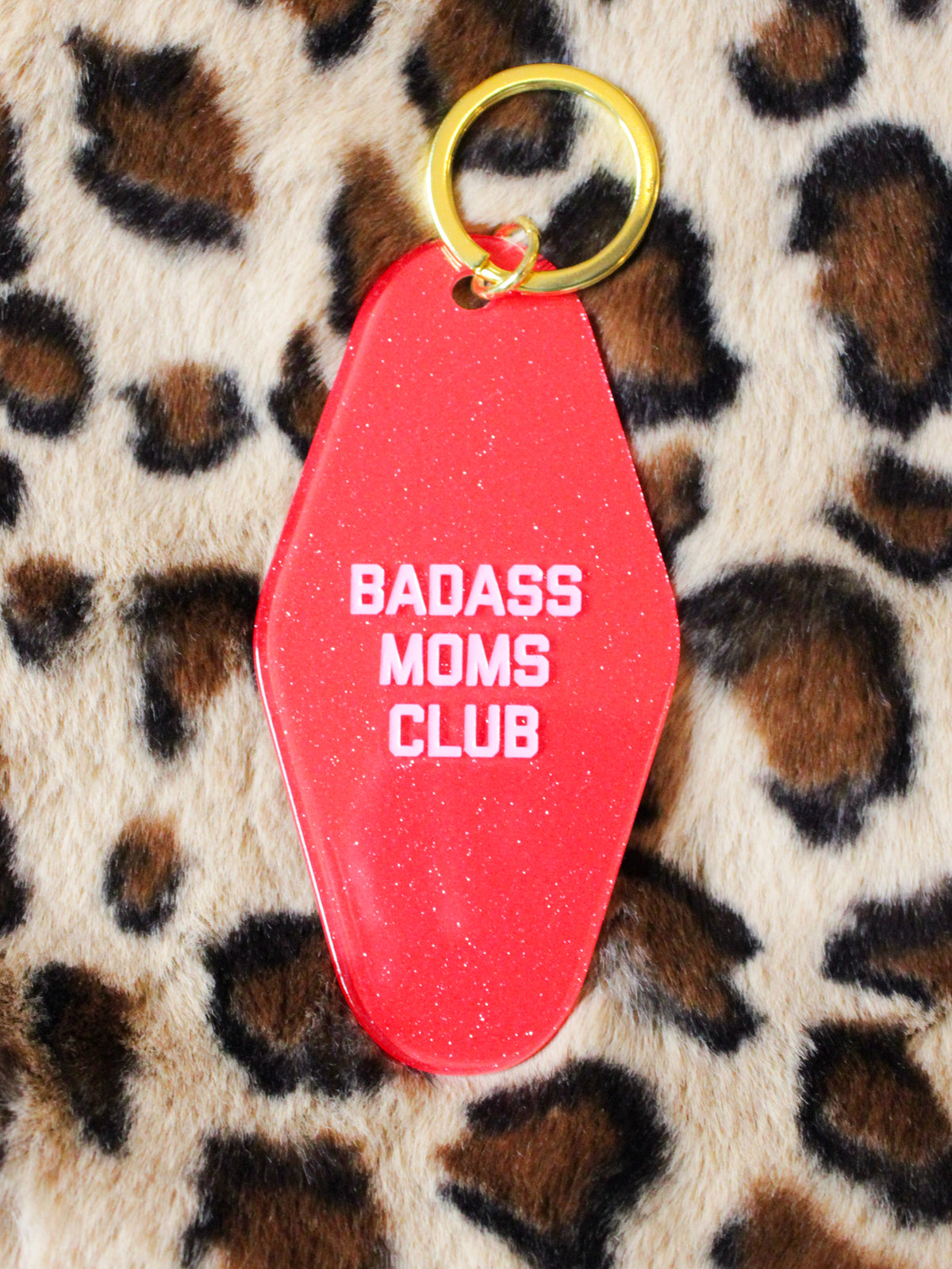 red, glittery keychain reads &quot;badass moms club&quot;