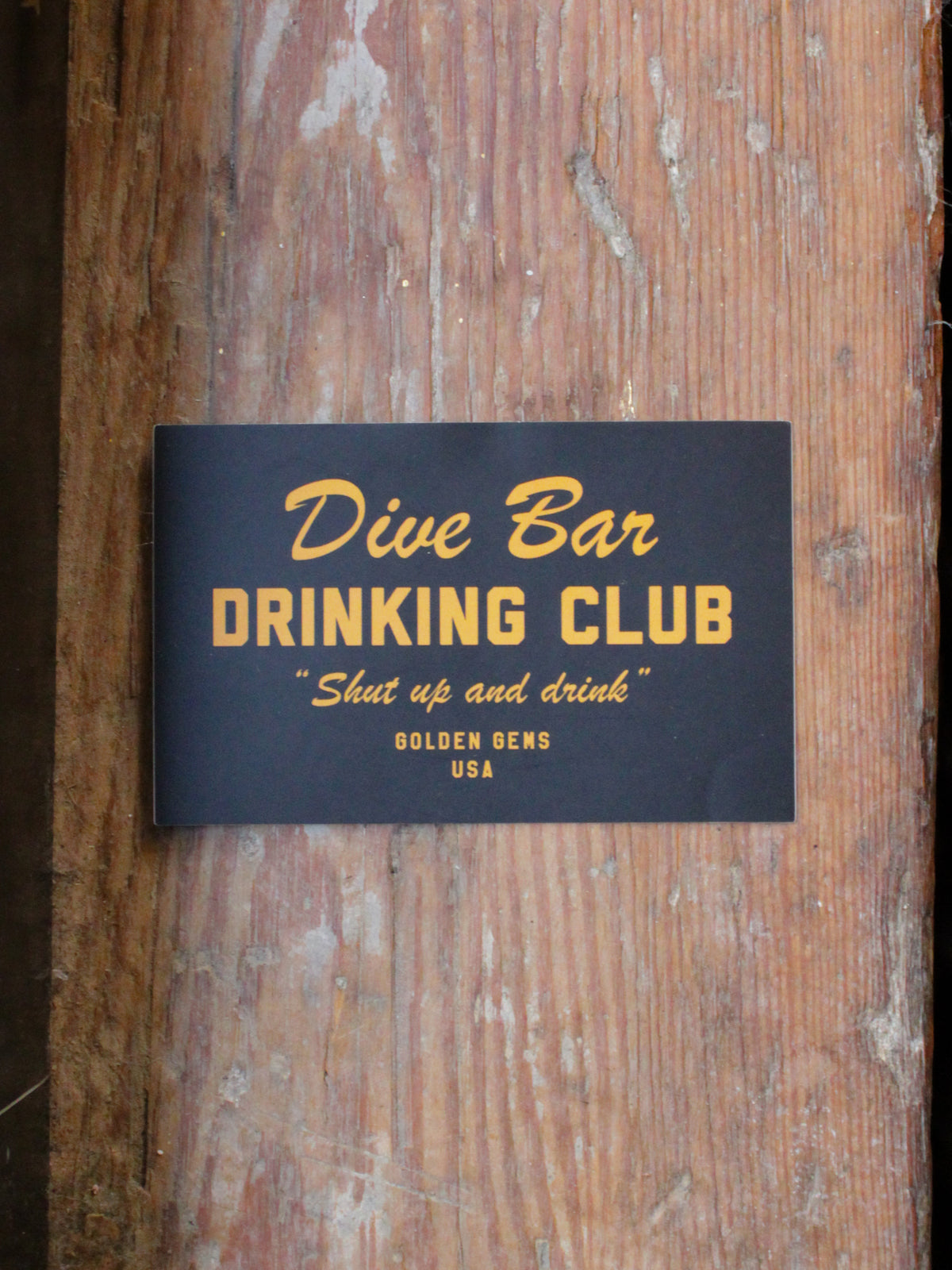 black and gold sticker reads &quot;dive bar drinking club; shut up and drink&quot;